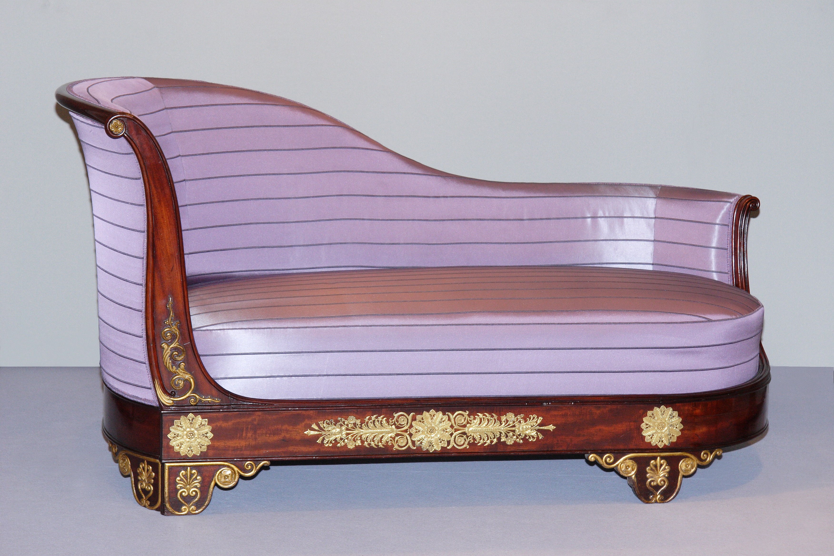 A late empire carved, veneered and gilt mahogany and ormolu mounted meridienne in the manner of Jeanselme